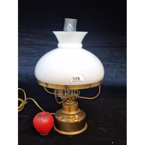 178 - A large brass oil lamp featuring an opaque white glass shade, converted to electricity. Lovely piece... 