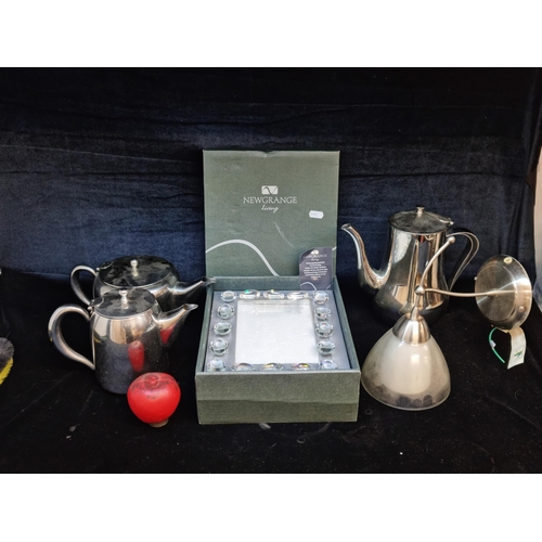 181 - A box containing a mixed lot of hotel ware teapots, coffee pots, a Newgrange NL jewel 5 x 7 photo fr... 