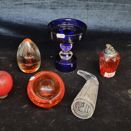 197 - An assorted lot of glass ware items including a vibrant orange faceted table lighter, a 1960s ash tr... 