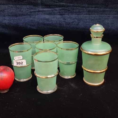 202 - A pretty art deco mint green and gilt gold decanter with six matching glasses.