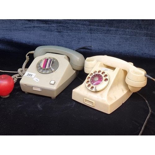 205 - Two vintage telephones including the Swedish made LM Ericsson Bakelite example in a cream finish.