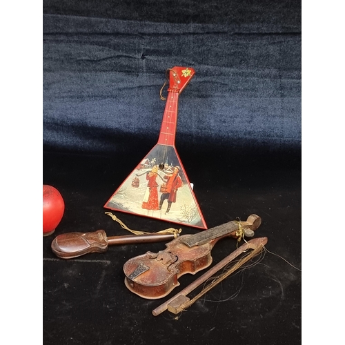 207 - Three miniature wooden models of musical instruments including a violin example.