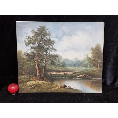 84 - A large oil on canvas painting . Features a calm riverside scene with woodland and lush green trees.... 