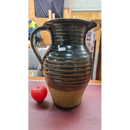 A lovely large handcrafted art pottery large ceramic jug with a two-tone glaze finish and classic ribbed design. In very good condition.