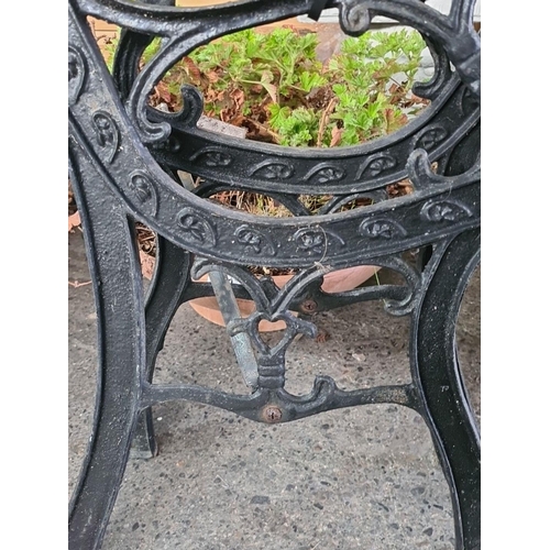 867 - A Victorian style cast iron garden bench with intricate foliate patterns and cabriole legs, suitable... 