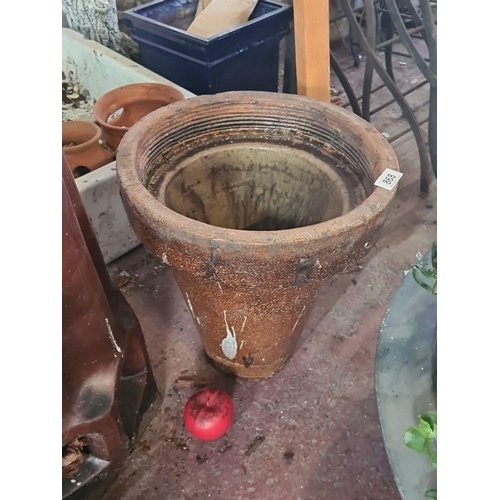 868 - A fabulous vintage Trumpet terracotta  planter, displaying a weathered patina with ribbed detailing,... 