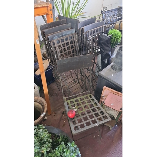 870 - A set of eight classic wrought iron garden chairs with lattice design on seat.