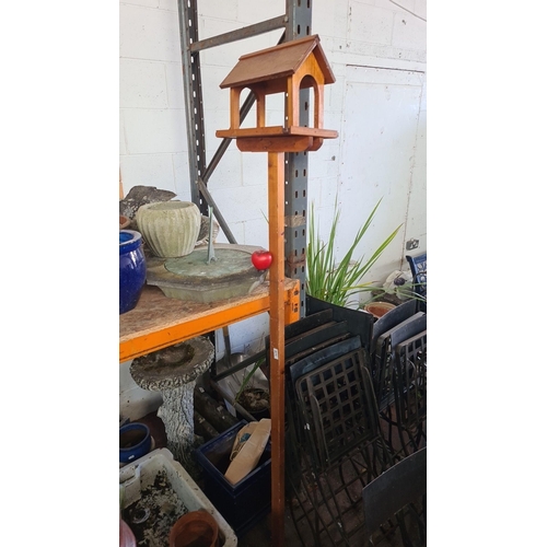 871 - A hand-crafted wooden bird feeder in warm toned wood finish. Approx 7 feet tall.