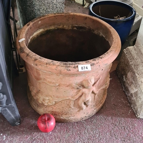 874 - An antique large  terracotta garden planter, featuring relief cherub designs.