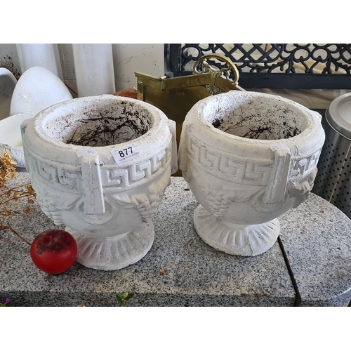 877 - An eye-catching pair of classical-style concrete garden urns, featuring a Greek key pattern and grap... 