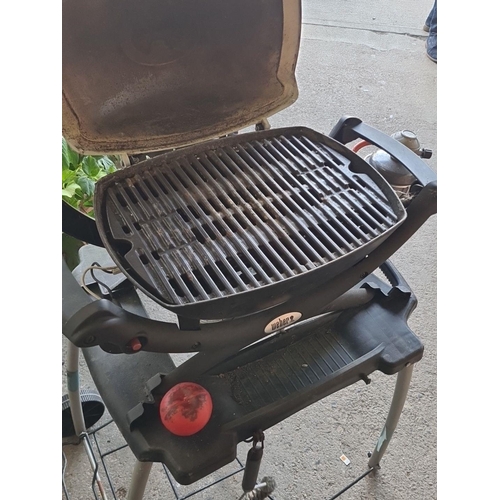 891 - Star lot : A Weber Baby Q portable gas barbecue grill. Features a durable design and easy mobility. ... 