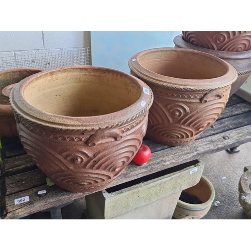 895 - Two large terracotta plant pots featuring ornate relief designs and drainage holes. Lovely pots thes... 