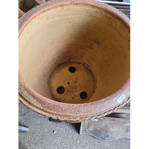 895 - Two large terracotta plant pots featuring ornate relief designs and drainage holes. Lovely pots thes... 