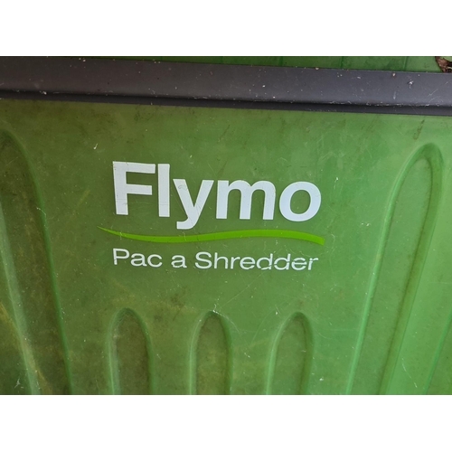 899 - A 'Flymo Pac a Shredder'  garden waste shredder in orange and green, with cable.
RRP: £199.99 on www... 