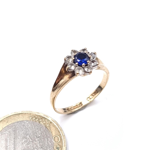 901 - Star Lot : A blue gemstone cluster ring set in nine carat gold (375) Size - M. Weight - 2.21 grams.