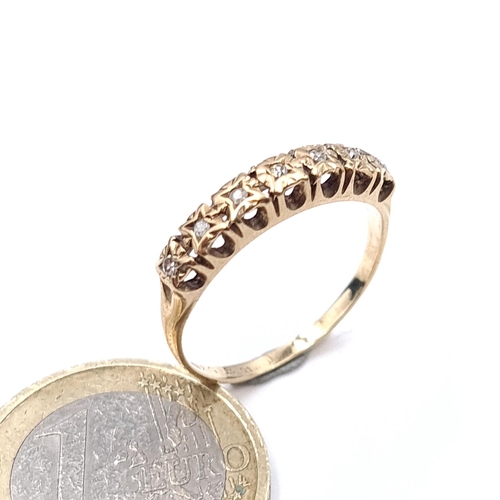 902 - Star Lot : A nine carat gold diamond half eternity ring. Size - R. Weight - 2.03 grams.