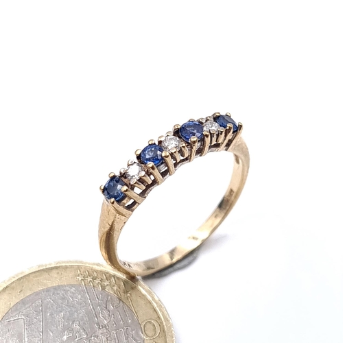 903 - Star Lot: A nine carat gold diamond and sapphire ring. Est. diamond weight 0.10 carats. Size - M. We... 