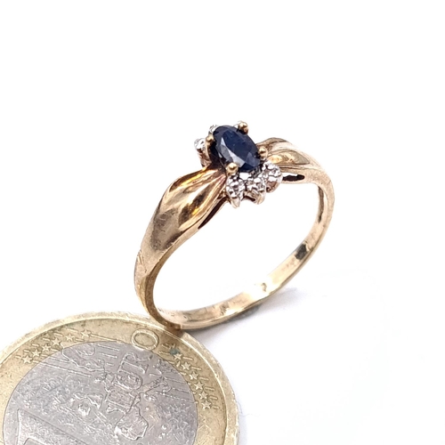 904 - A very pretty 9ct  gold ring with sapphire central stone. Size - O. Weight - 1.72 grams.