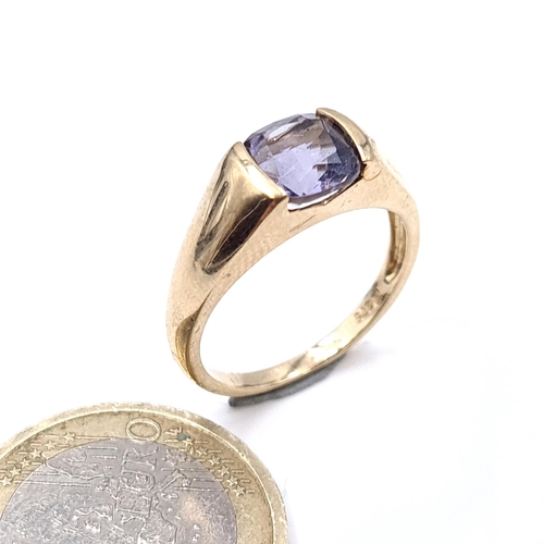 906 - Star Lot: A nine carat gold (375) wide band gold ring set with a bright Amethyst stone. Size - N. We... 