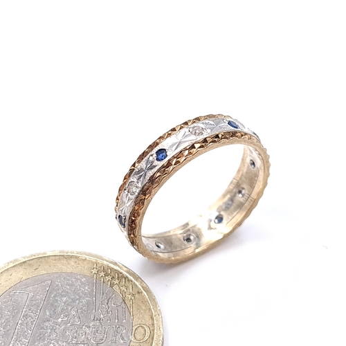 908 - Star Lot: A vintage nine carat gold diamond and sapphire eternity ring. Size - L. Weight - 2.47 gram... 