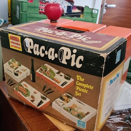 938 - A vintage Pac-a-Pic portable picnic set in original box, vibrant retro orange and white design.