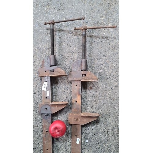 945 - A Pair of vintage industrial steel slash clamps with red handles.