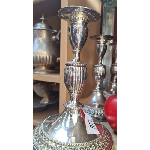 977 - Set of three silver-plated candlesticks featuring intricate detailing and beaded rims, elegant for a... 