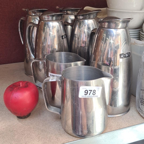 978 - A selection of five stainless steel commercial quality  Elia branded pitchers and two jugs.