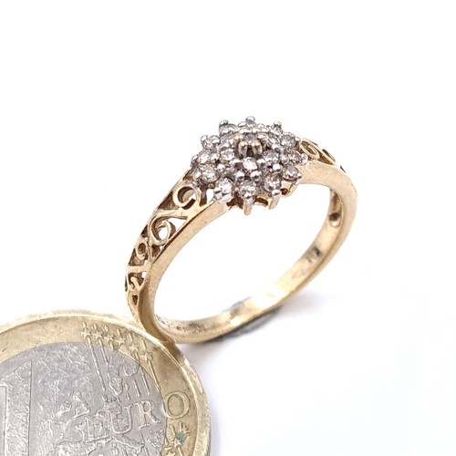 913 - Star Lot: A beautiful 9k gold diamond cluster ring in a crown setting. Featuring scroll detailing on... 