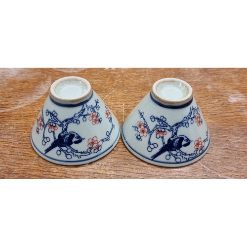 149 - A pretty pair of antique small sake ceramic wine cups. Features nice floral and bird motifs with rei... 