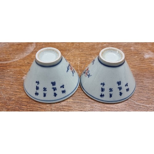 149 - A pretty pair of antique small sake ceramic wine cups. Features nice floral and bird motifs with rei... 