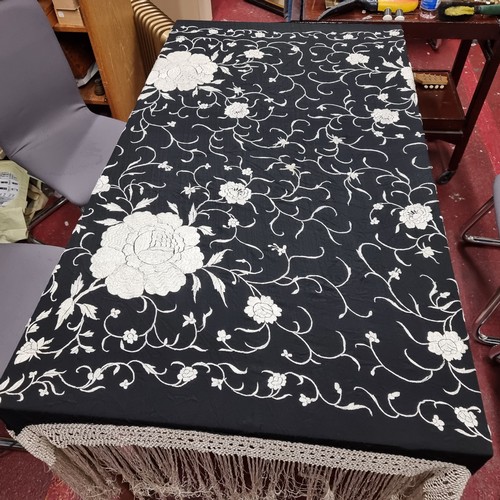 173 - A beautiful piano black cloth cover featuring a contrasting stitch of floral accents and fringe deta... 