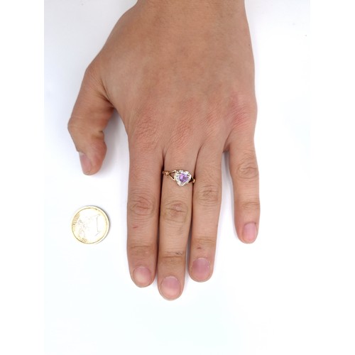 12 - Star lot : A pretty nine carat gold Amethyst stone ring in a heart setting with diamond surround. Ri... 