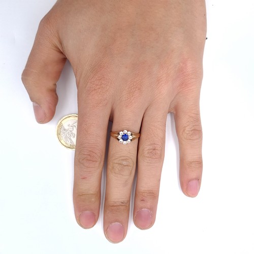 901 - Star Lot : A blue gemstone cluster ring set in nine carat gold (375) Size - M. Weight - 2.21 grams.