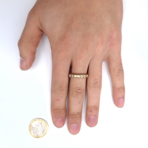 902 - Star Lot : A nine carat gold diamond half eternity ring. Size - R. Weight - 2.03 grams.