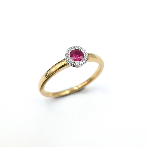 14 - A nine carat gold (375) ruby set ring with diamond halo surround. Ring size - O. Weight - 2.08 grams... 