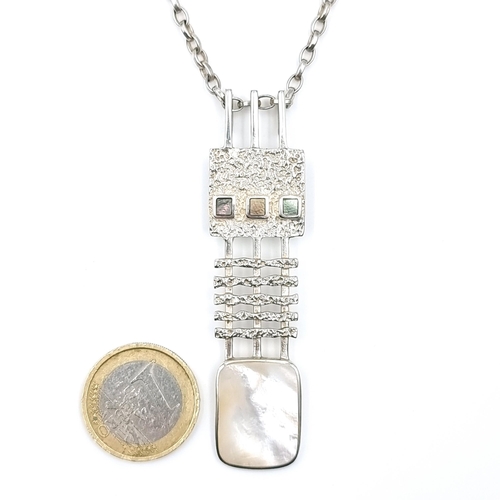 18 - An unusual mother of pearl pendant necklace marked (925) silver together with link chain. Length of ... 