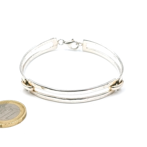 25 - A sterling silver (925) double banded hammered silver bracelet set with lobster clasps. Weight - 23.... 