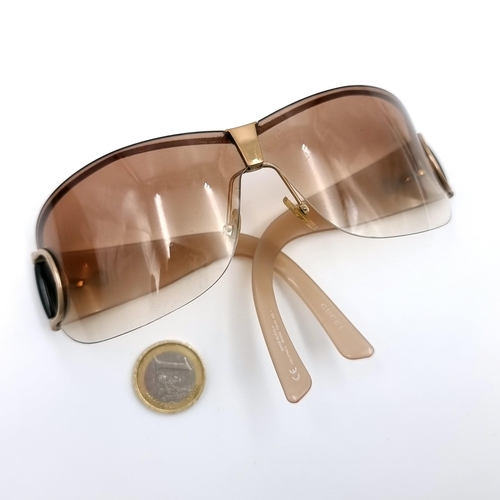 35 - A pair of genuine designer Gucci wrap around style sunglasses marked Gucci to frames. Lenses in clea... 