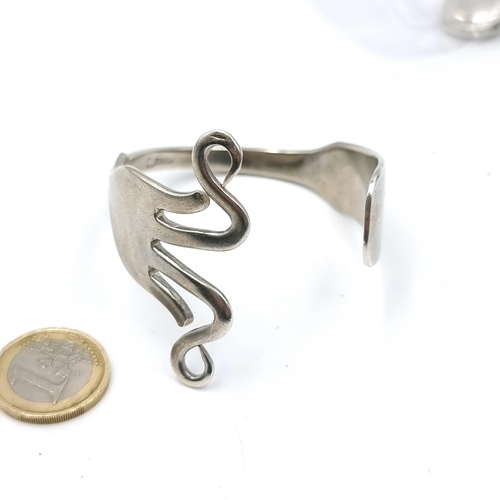 55 - A Celtic designed sterling silver Torc bracelet with initial 'D'. Weight - 48.9 grams.