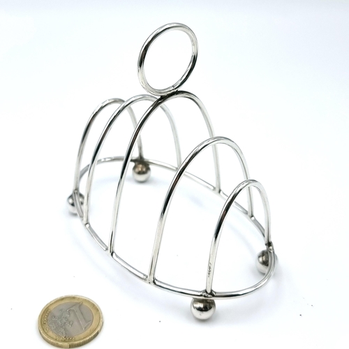 60 - A very pretty and attractive four section sterling silver toast rack standing on ball feet. Hallmark... 