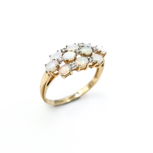 9 - Star Lot : A most attractive 10 stone opal ring set with diamond, Ring marked 9K to band. Ring size ... 