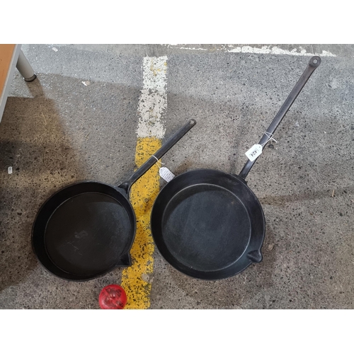 1424 - Two metal long handled cast iron skillet pans.