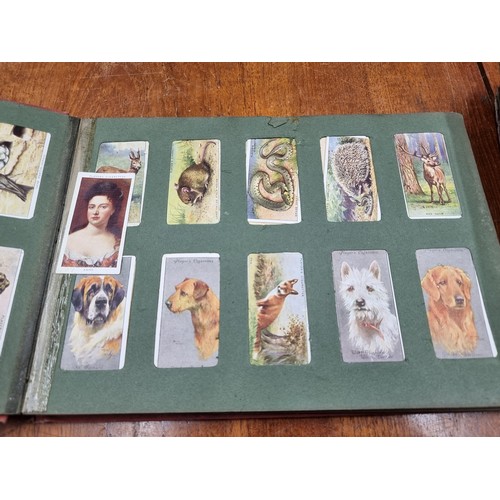 153 - Four fairly full fabulous vintage cigarette picture albums. Albums feature brands such as Players an... 