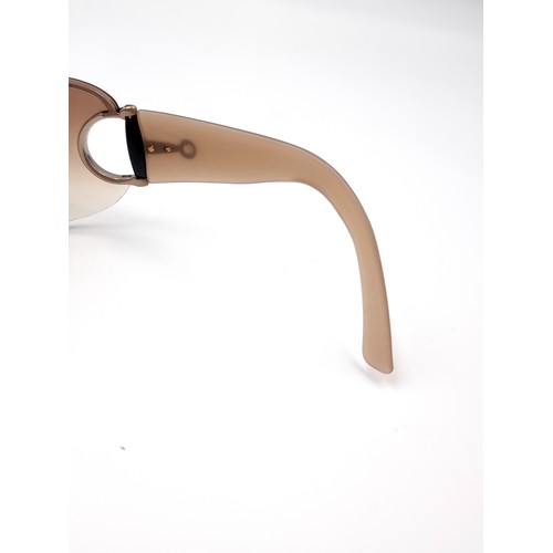 35 - A pair of genuine designer Gucci wrap around style sunglasses marked Gucci to frames. Lenses in clea... 