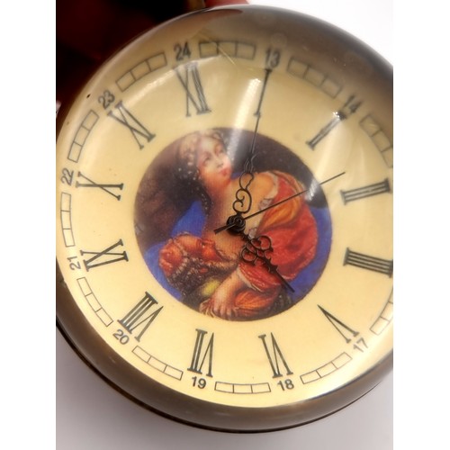 38 - A vintage large crystal ball table bull clock depicting a coloured portraiture. Dimensions: 8 cms di... 