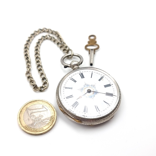 12 - A sterling silver pocket watch with white enamel face and roman numeral dial with a decorated cartou... 