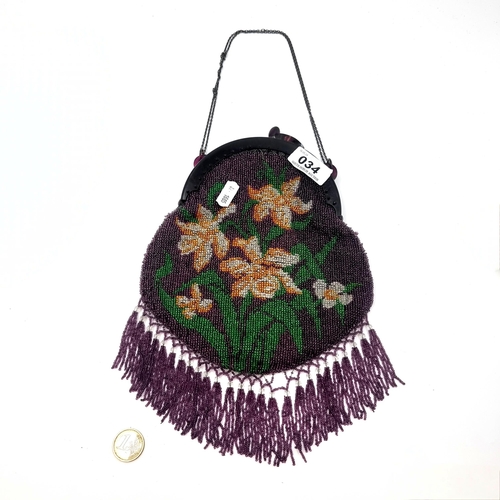 34 - A very attractive vintage evening bag with chain handle set with floral beaded design with bead tass... 