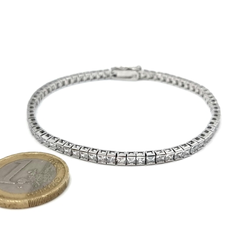 47 - A sterling silver tennis line gem set bracelet. Presented in d'Alton presentation box.