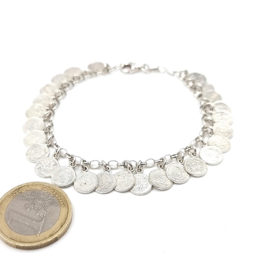 50 - A sterling silver panel bracelet of miniature coins. Weight - 13.42 grams.